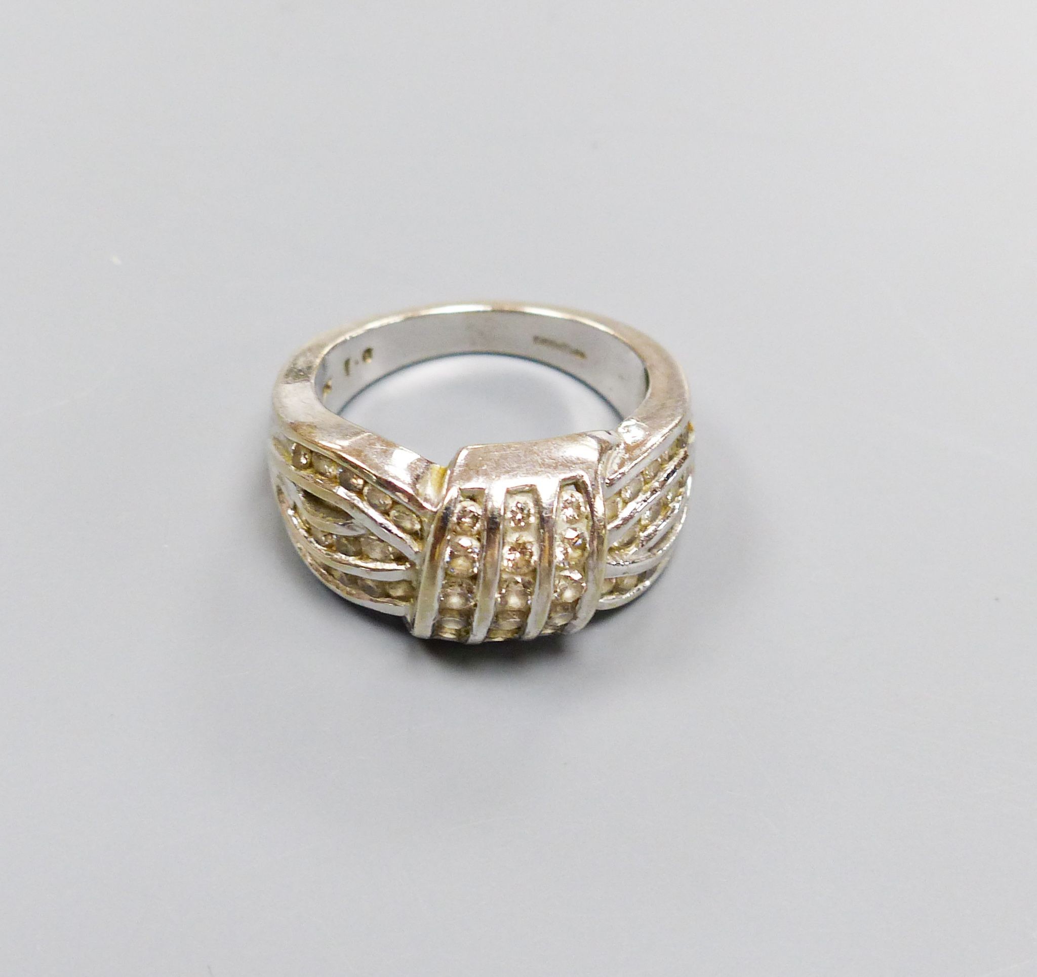 A modern 9ct white gold and diamond encrusted 'knot' ring, size M/N, gross 6.7 grams.
